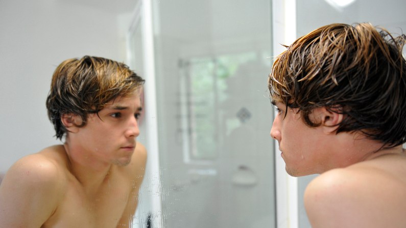 purpose 1 young man looking at himself in the mirror